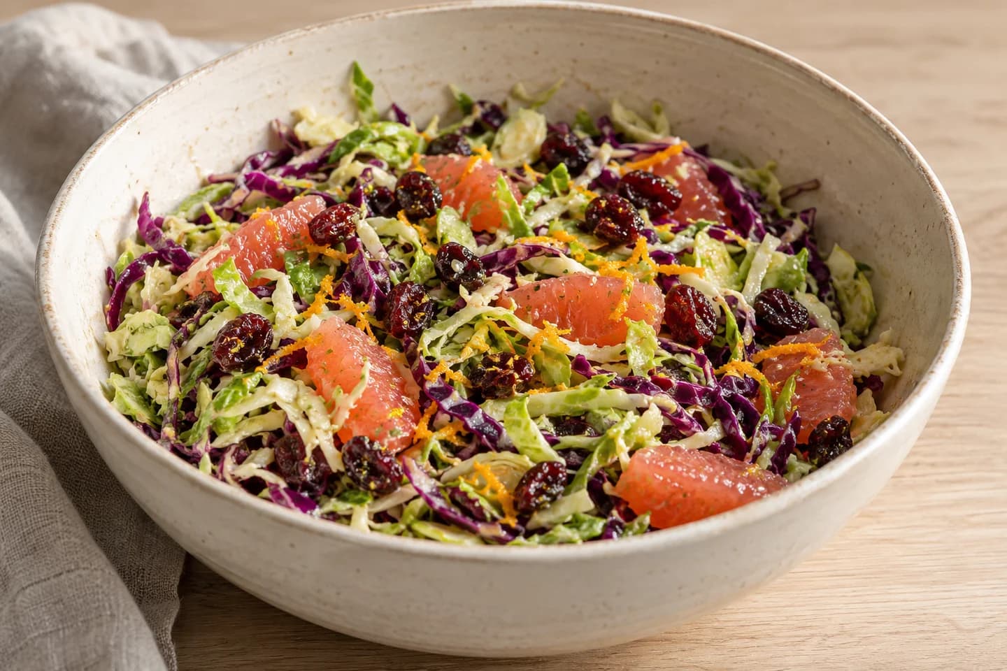 Cranberry Citrus Brussels Slaw: Fold in grapefruit segments, dried cranberries, and orange zest