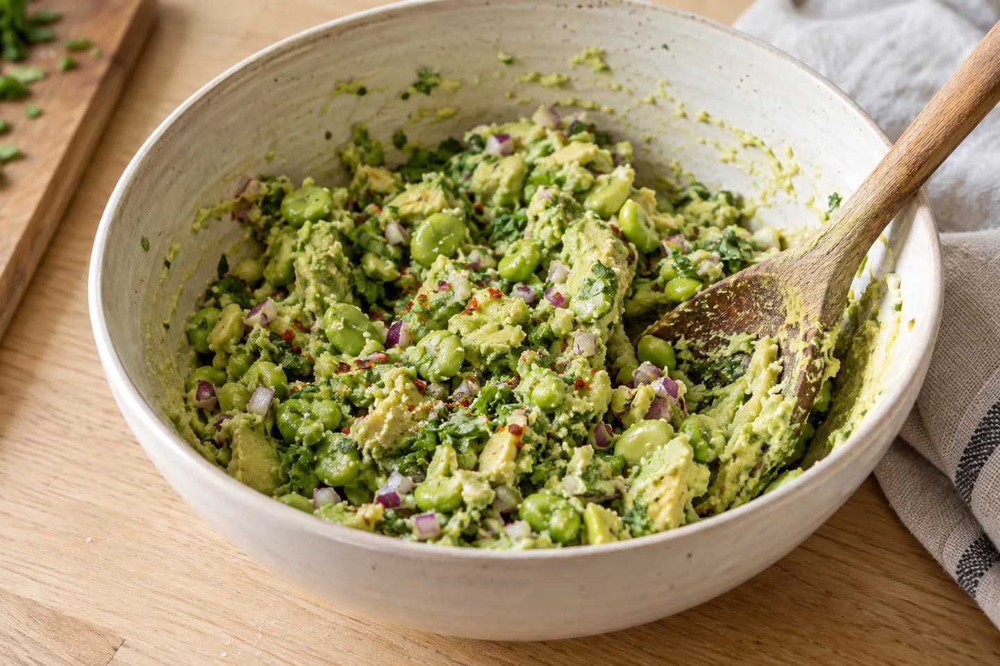 Edamame Lime Guacamole: Mash avocado in a bowl and fold in edamame, onion, cilantro, salt and chili