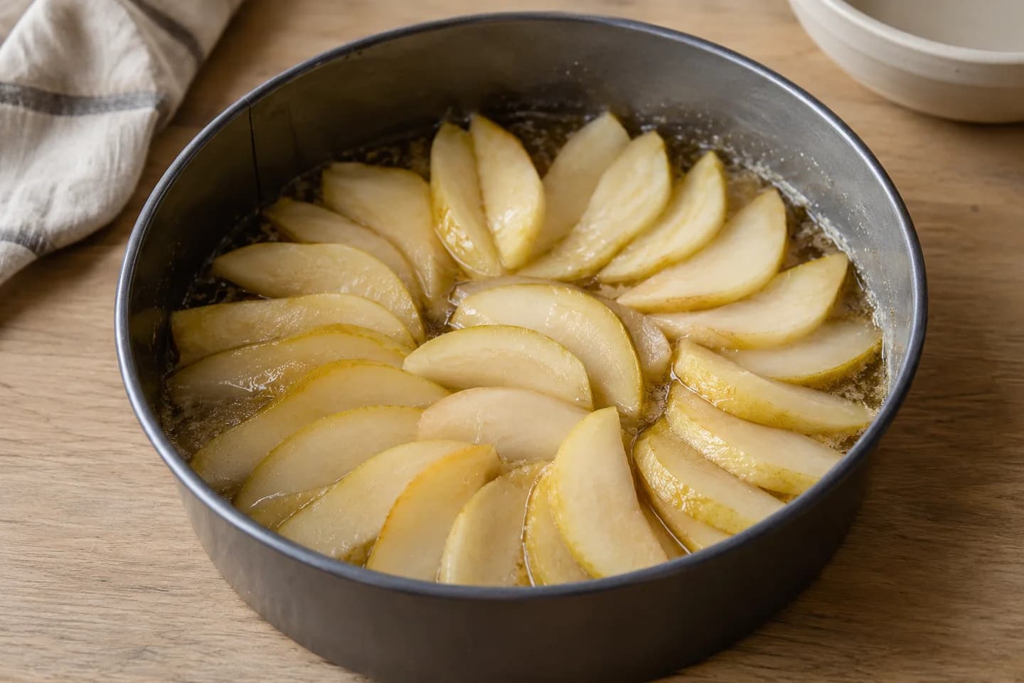 Pear Ginger Upside-Down Cake: Spread melted vegan butter and 40 g sugar in the base
